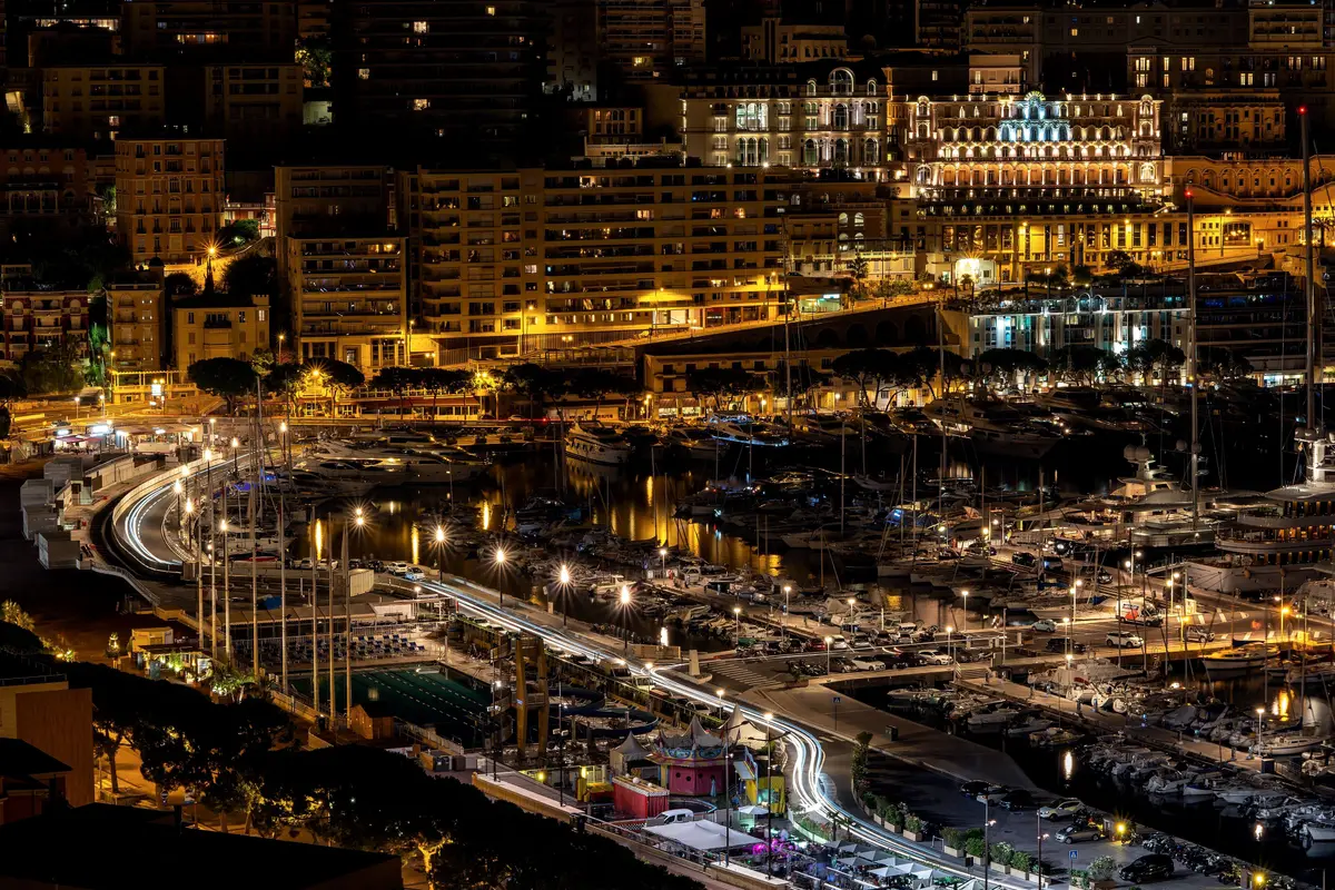 Port Hercule at night, the quays and apartment blocks of Monte-Carlo lit gold above the dark water
